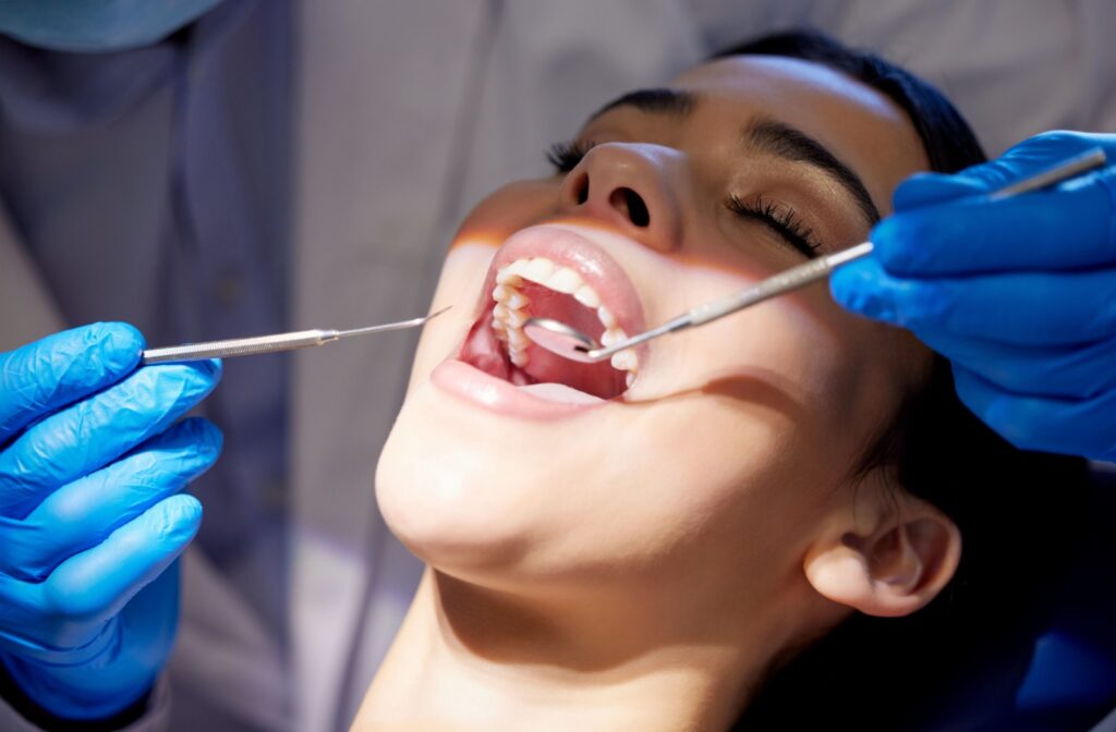 A patient sitting in a dental chair getting a recall exam done