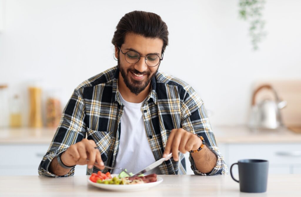 A person eating a healthy plate of food after getting a teeth cleaning