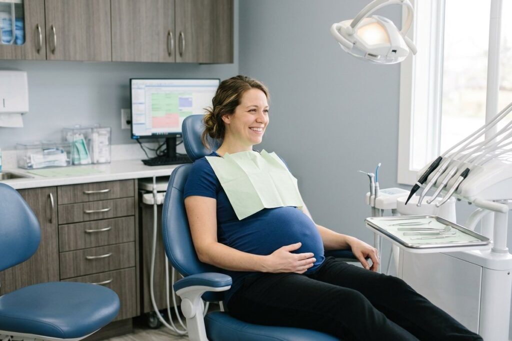 A pregnant woman sitting in a dental chair ready for a routine dental exam